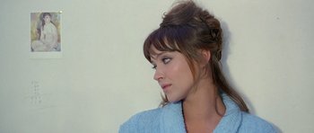 Movie still from “Pierrot le Fou” (1965), directed by Jean-Luc Godard – A person wearing a blue robe; Close Up shot, Over the shoulder angle