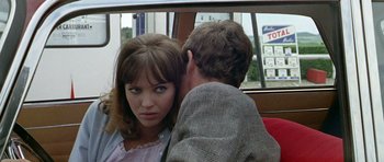 Movie still from “Pierrot le Fou” (1965), directed by Jean-Luc Godard – A man and a woman on a bus; Close Up shot, Over the shoulder angle
