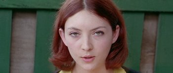 Movie still from “Pierrot le Fou” (1965), directed by Jean-Luc Godard – A person wearing a yellow shirt; Close Up shot, Low angle