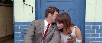 Movie still from “Pierrot le Fou” (1965), directed by Jean-Luc Godard – A man and a woman sitting next to each other; Close Up shot, Low angle