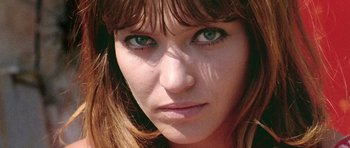 Movie still from “Pierrot le Fou” (1965), directed by Jean-Luc Godard – A woman's face with green eyes; Close Up shot, Low angle