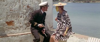 Movie still from “Pierrot le Fou” (1965), directed by Jean-Luc Godard – A man and a woman sitting next to each other; Medium shot, High angle
