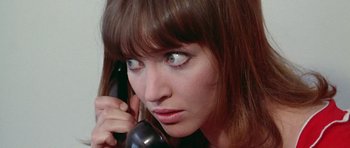 Movie still from “Pierrot le Fou” (1965), directed by Jean-Luc Godard – A person talking on a phone; Close Up shot, High angle