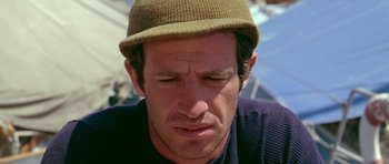 Movie still from “Pierrot le Fou” (1965), directed by Jean-Luc Godard – A person wearing a hat; Close Up shot, Low angle