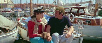 Movie still from “Pierrot le Fou” (1965), directed by Jean-Luc Godard – A man and a woman sitting next to each other on a boat; Medium shot, High angle