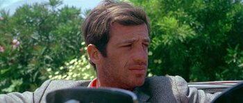 Movie still from “Pierrot le Fou” (1965), directed by Jean-Luc Godard – A person wearing a jacket; Close Up shot, Low angle