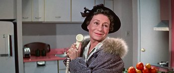 Movie still from “Pillow Talk” (1959), directed by Michael Gordon – An older woman holding a phone up to her ear; Close Up shot, Low angle