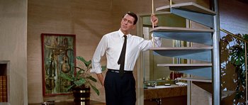 Movie still from “Pillow Talk” (1959), directed by Michael Gordon – A man in a white shirt and black tie; Medium shot, Low angle