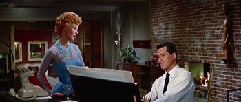 Movie still from “Pillow Talk” (1959), directed by Michael Gordon – A man and a woman sitting in front of an easel in a room; Medium shot, Over the shoulder angle