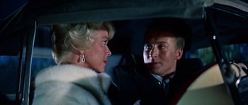 Movie still from “Pillow Talk” (1959), directed by Michael Gordon – A man and a woman sitting in the back of a car; Close Up shot, Low angle