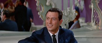 Movie still from “Pillow Talk” (1959), directed by Michael Gordon – A person wearing a suit and a tie; Close Up shot, Low angle