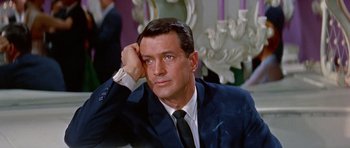 Movie still from “Pillow Talk” (1959), directed by Michael Gordon – A person wearing a suit and tie; Close Up shot, High angle