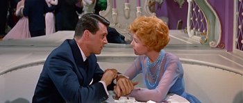 Movie still from “Pillow Talk” (1959), directed by Michael Gordon – A man and a woman sitting at a dinner table; Medium shot, Over the shoulder angle