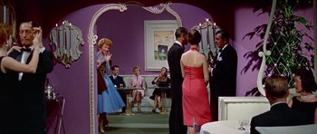 Movie still from “Pillow Talk” (1959), directed by Michael Gordon – A group of people standing in a room; Wide shot, Low angle