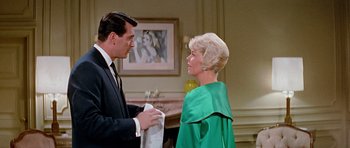 Movie still from “Pillow Talk” (1959), directed by Michael Gordon – A man and a woman standing next to each other in a room; Medium shot, Low angle