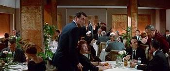Movie still from “Pillow Talk” (1959), directed by Michael Gordon – A man and a woman sitting at a dinner table; Wide shot, Over the shoulder angle