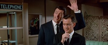 Movie still from “Pillow Talk” (1959), directed by Michael Gordon – Two men in suits and ties standing next to each other; Medium shot, Low angle