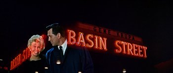 Movie still from “Pillow Talk” (1959), directed by Michael Gordon – A man standing in front of a neon sign; Medium shot, Low angle