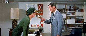 Movie still from “Pillow Talk” (1959), directed by Michael Gordon – An older man and a younger woman in an office setting; Medium shot, Over the shoulder angle