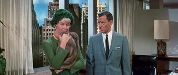 Movie still from “Pillow Talk” (1959), directed by Michael Gordon – A man and a woman standing next to each other in front of a building; Medium shot, Over the shoulder angle