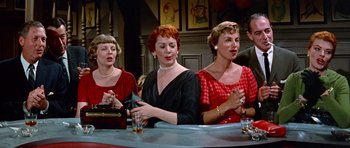 Movie still from “Pillow Talk” (1959), directed by Michael Gordon – A group of women sitting at a bar; Medium shot, High angle