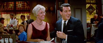 Movie still from “Pillow Talk” (1959), directed by Michael Gordon – An older couple sitting at a dinner table; Medium shot, Low angle