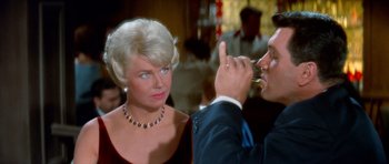 Movie still from “Pillow Talk” (1959), directed by Michael Gordon – An older woman and a younger man are drinking; Close Up shot, Over the shoulder angle