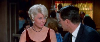 Movie still from “Pillow Talk” (1959), directed by Michael Gordon – An older woman talking to a younger man in front of a crowd; Close Up shot, Over the shoulder angle