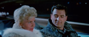 Movie still from “Pillow Talk” (1959), directed by Michael Gordon – A man and a woman are standing next to each other in a car; Close Up shot, Over the shoulder angle