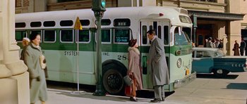 Movie still from “Pillow Talk” (1959), directed by Michael Gordon – A man and a woman standing next to a green bus; Wide shot, High angle