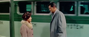 Movie still from “Pillow Talk” (1959), directed by Michael Gordon – A man and a woman standing next to each other on the street; Medium shot, Over the shoulder angle