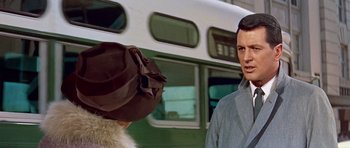 Movie still from “Pillow Talk” (1959), directed by Michael Gordon – A man and a woman standing in front of a bus; Medium shot, Over the shoulder angle