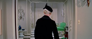 Movie still from “Pillow Talk” (1959), directed by Michael Gordon – A woman in a black jacket and a black hat; Medium shot, Over the shoulder angle
