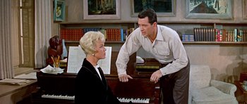 Movie still from “Pillow Talk” (1959), directed by Michael Gordon – A man and a woman sitting in front of a grand piano; Medium shot, High angle