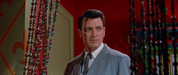 Movie still from “Pillow Talk” (1959), directed by Michael Gordon – A person wearing a suit and tie; Close Up shot, Low angle