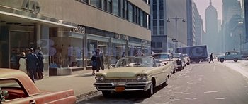 Movie still from “Pillow Talk” (1959), directed by Michael Gordon – An old car parked on the side of the street; Wide shot, Low angle