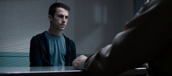 Movie still from “13 Reasons Why” (2017), created by Brian Yorkey – A man sitting in front of another man in front of a table; Close Up shot, Over the shoulder angle