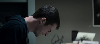 Movie still from “13 Reasons Why” (2017), created by Brian Yorkey – A young man is looking down at his face; Close Up shot, Low angle