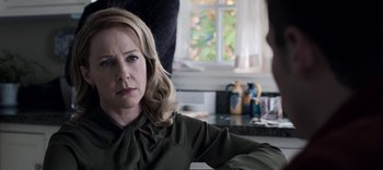 Movie still from “13 Reasons Why” (2017), created by Brian Yorkey – A woman sitting at a table in front of a window; Close Up shot, Over the shoulder angle