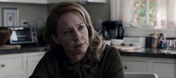 Movie still from “13 Reasons Why” (2017), created by Brian Yorkey – A person sitting at a table; Close Up shot, Over the shoulder angle