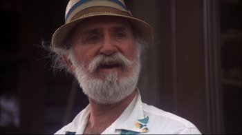 Movie still from “Piranha” (1978), directed by Joe Dante – An older man with a beard and a hat; Close Up shot, Low angle