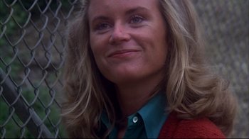 Movie still from “Piranha” (1978), directed by Joe Dante – A person with long blonde hair; Close Up shot, Low angle