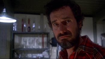 Movie still from “Piranha” (1978), directed by Joe Dante – A person with a beard; Close Up shot, Low angle