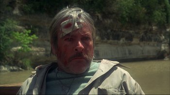Movie still from “Piranha” (1978), directed by Joe Dante – A person with a bandage on his head; Close Up shot, Low angle