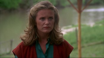 Movie still from “Piranha” (1978), directed by Joe Dante – A person with long blonde hair; Close Up shot, Over the shoulder angle