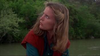 Movie still from “Piranha” (1978), directed by Joe Dante – A woman with long blonde hair looking to her left; Close Up shot, Low angle