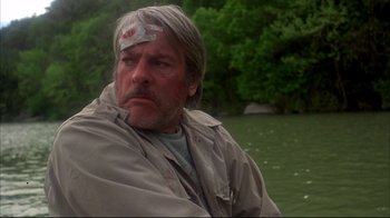 Movie still from “Piranha” (1978), directed by Joe Dante – A person wearing a head band; Close Up shot, Low angle