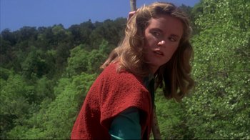 Movie still from “Piranha” (1978), directed by Joe Dante – A woman with long hair wearing a red sweater; Close Up shot, Low angle
