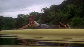 Movie still from “Piranha” (1978), directed by Joe Dante – A man riding a skateboard down the side of a ramp; Wide shot, High angle