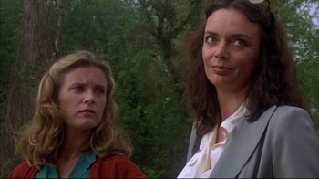 Movie still from “Piranha” (1978), directed by Joe Dante – Two women standing next to each other near a forest; Close Up shot, Low angle